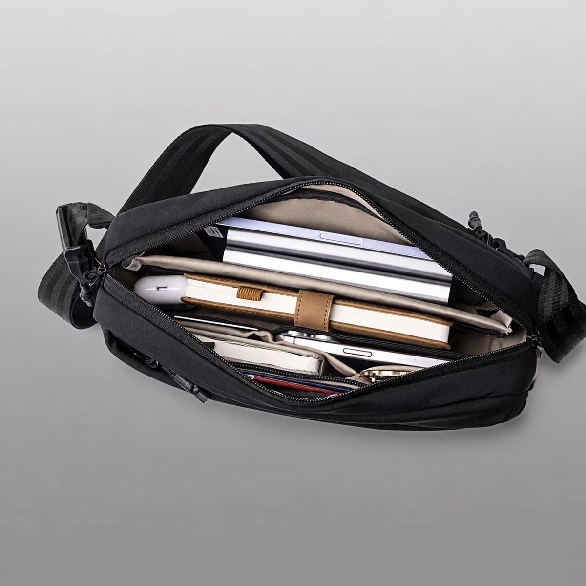 Roam Sling Bag open showing organized storage capacity